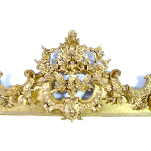 910 - A giltwood and composite overmantel mirror, late 18th century and later, in Rococo style frame with ... 