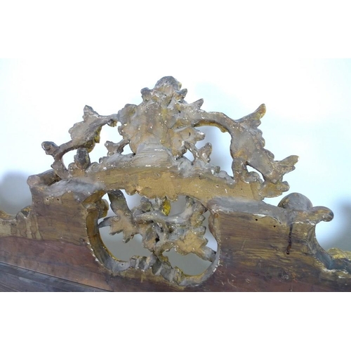 910 - A giltwood and composite overmantel mirror, late 18th century and later, in Rococo style frame with ... 