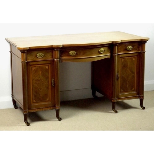 913 - An Edwardian mahogany bow and break fronted desk, attributed to Gillows, Lancaster, with satinwood c... 