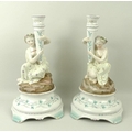 A pair of Dresden figural candlesticks, depicting classical maidens with conical holders, the circul... 