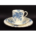 A part tea service, mid 19th century, with scallop fluted cups and plates, decorated with blue flowe... 