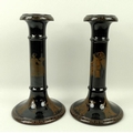 A pair of Samuel Alcock & Co candlesticks, circa 1840, in the Greek style, the black glazed body dec... 