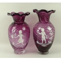 A near pair of Mary Gregory style thistle vases the twisted cranberry glass painted with a girl play... 