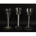 A group of three wine glasses, with double air twist stems and bucket and bell shaped bowls, with cu... 