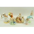 A group of six ceramic figurines, comprising a Beswick Ware Royal Doulton, 'Punch' and 'Judy', model... 