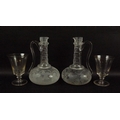 A pair of cut glass decanters, possibly Waterford, with spout and handle, engraved with Asian pheasa... 
