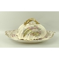 A Victorian nautilus shell shaped cheese dish, with gilded fish handle, 24 by 15cm, and a similar pl... 