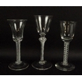 A group of three 18th century wine glasses, with cut pontils and double air twist stems, two with bu... 