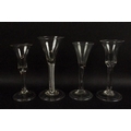 A group of four 18th century wine glasses, with folded feet air twist and tear drop stems, two bell ... 