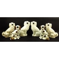 A pair of Staffordshire King Charles spaniel fire dogs, in white ground with lustre glaze, 28cm, and... 