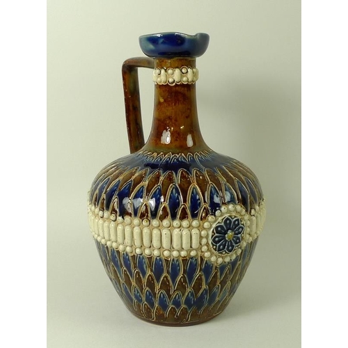 555 - A Doulton Lambeth jug, the incised decoration depicting 'scales' and a 'beaded' belt, of ovoid form,... 