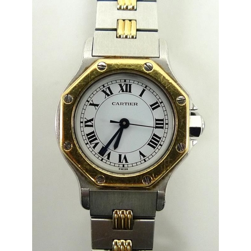 835 - A Cartier Santos lady's wristwatch, the circular white face with Roman numerals, with external hexag... 