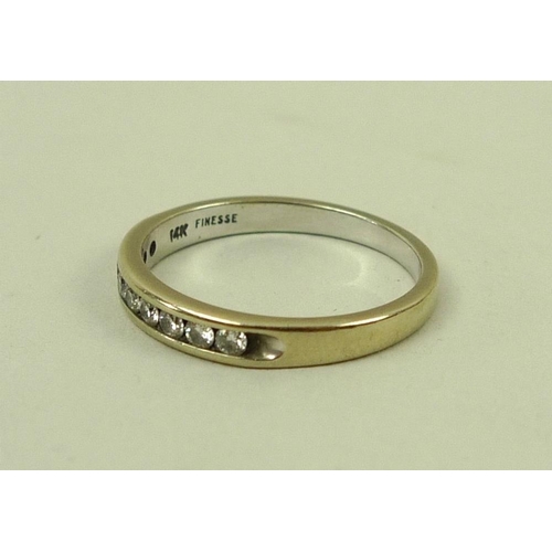 836 - A 14k gold and diamond half eternity ring, set with nine diamonds, size N, 2.3g.