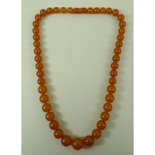 839 - An amber graduated bead necklace of forty-six beads, butterscotch colour, 51cm long, 42g.