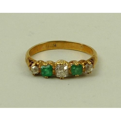 842 - An 18ct gold, diamond and emerald five stone ring of three diamonds and two emeralds, central diamon... 