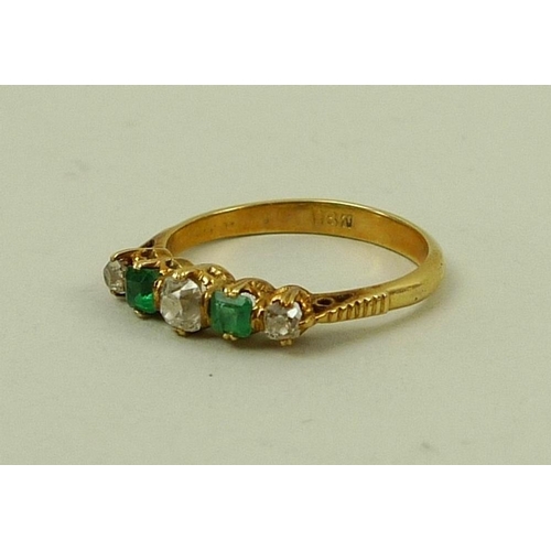 842 - An 18ct gold, diamond and emerald five stone ring of three diamonds and two emeralds, central diamon... 