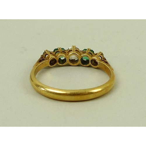 842 - An 18ct gold, diamond and emerald five stone ring of three diamonds and two emeralds, central diamon... 