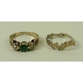An 18ct gold, emerald and diamond three stone ring, illusion set with two diamonds either side of an... 