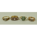 A group of four 9ct gold rings, comprising an illusion set diamond solitaire ring with hearts to the... 