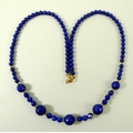 A Lapis Lazuli and 18ct gold necklace, with five large faceted beads divided by three smaller facete... 