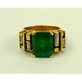 An 18ct gold, emerald and diamond ring, 1960s in brutalist style, the central baguette cut emerald, ... 