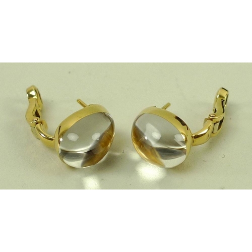 856 - A pair of Cartier 18ct gold and diamond earrings, the diamonds pave set under a teardrop cabochon cr... 