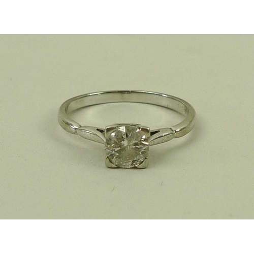 857 - An 18ct white gold diamond solitaire ring, the central round cut diamond 0.5ct, in four corner claw ... 