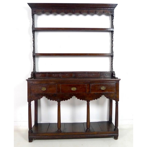 996 - An early Georgian oak dresser and rack of small proportions, with stepped cornice over a shaped frie... 