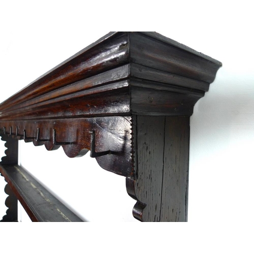 996 - An early Georgian oak dresser and rack of small proportions, with stepped cornice over a shaped frie... 