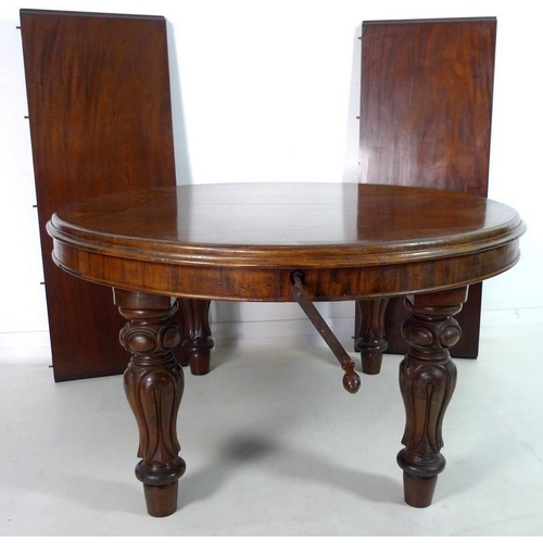 998 - An early Victorian mahogany extending dining table, the circular surface with moulded edge, raised o... 