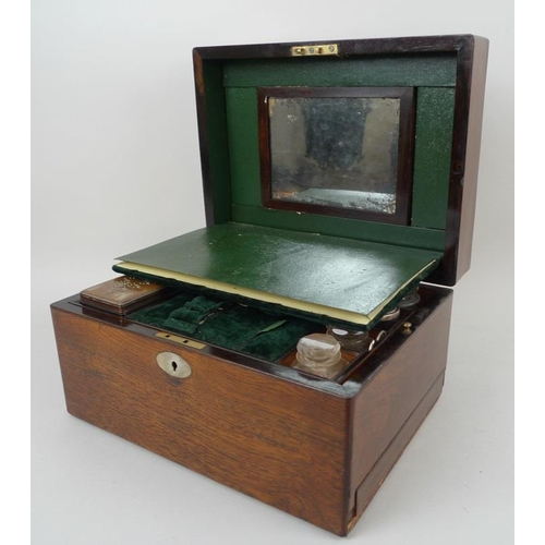 707 - A 19th century oak vanity case, fully fitted interior to include nine glass bottles with covers, a f... 