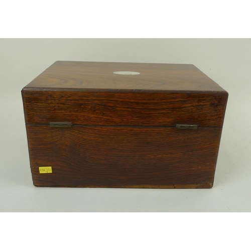 707 - A 19th century oak vanity case, fully fitted interior to include nine glass bottles with covers, a f... 