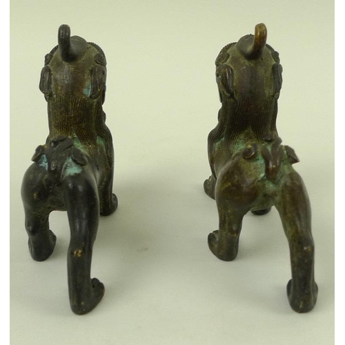 708 - A pair of bronze figures, modelled as Dogs of Fo standing with jaws open, 12 by 10cm. (2)