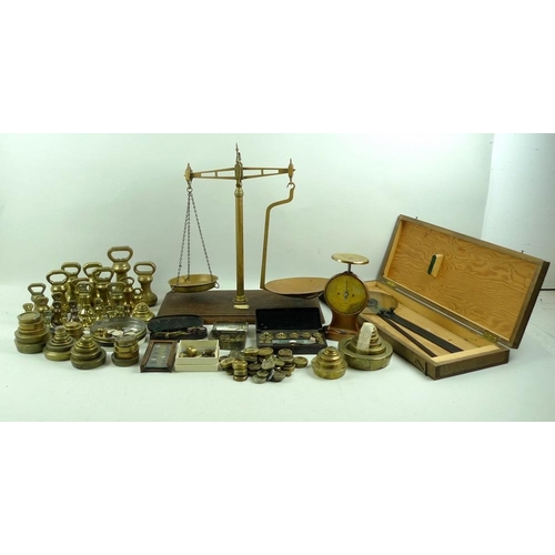 711 - A collection of brass weights, including some sets, a set of R. W. Lomas brass scales on wooden base... 