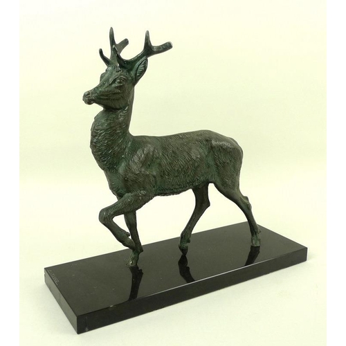 718 - A bronzed pewter figure of a stag, modelled standing, on a black marble base, bears the signature M.... 