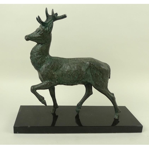 718 - A bronzed pewter figure of a stag, modelled standing, on a black marble base, bears the signature M.... 