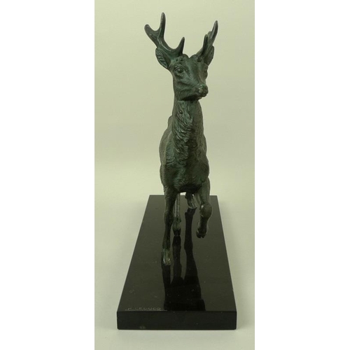 718 - A bronzed pewter figure of a stag, modelled standing, on a black marble base, bears the signature M.... 