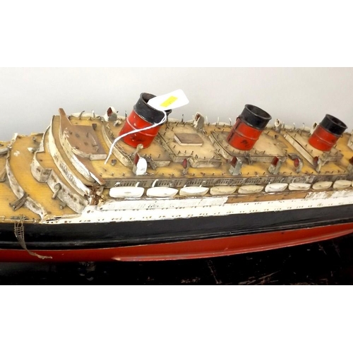 719 - A painted wooden model of the Queen Mary, mid 20th century, with burgundy and black hull, on a woode... 