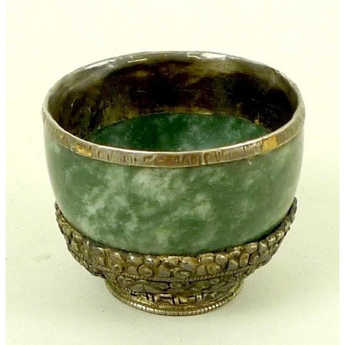 725 - A 19th century jade and Chinese white metal mounted cup, with covered rim, the base decorated with g... 