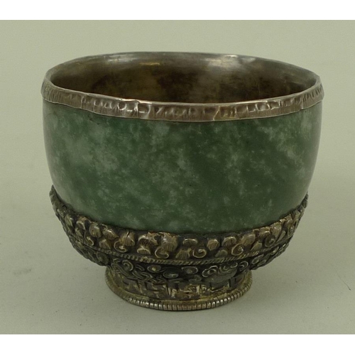 725 - A 19th century jade and Chinese white metal mounted cup, with covered rim, the base decorated with g... 