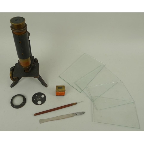 732 - An early 20th century microscope with brass body and an iron base, 26cm, together with four glass sl... 