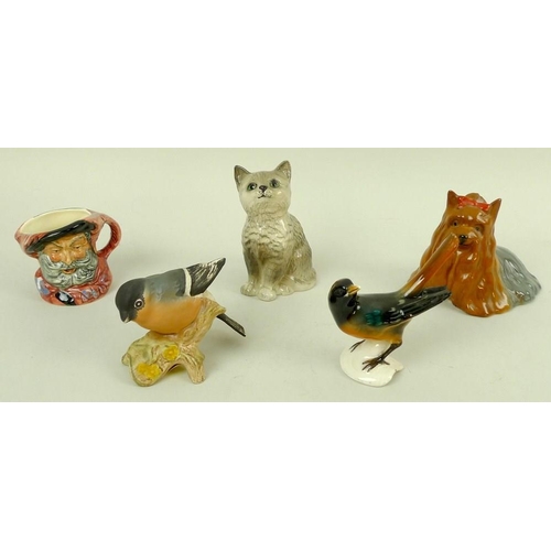 736 - A group of ceramic figurines, 20th century, comprising a Royal Doulton grey seated cat, 10cm, a mini... 