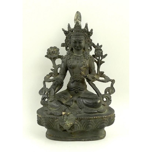 737 - A South East Asian bronze figure of a seated Bodhisattva on a lotus flower, 14.5cm high.