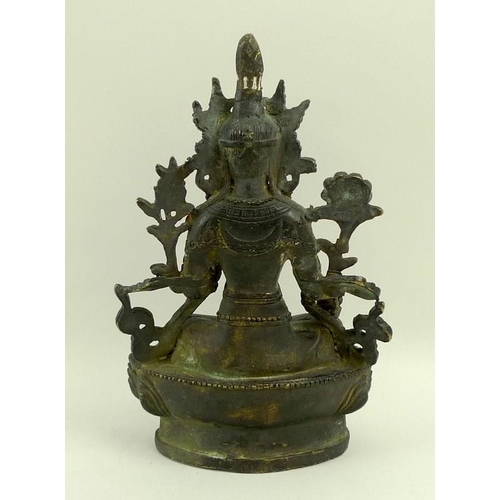 737 - A South East Asian bronze figure of a seated Bodhisattva on a lotus flower, 14.5cm high.