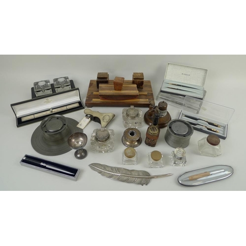 743 - A collection of desk items, including a silver plated letter opener, a variety of inkwells in pewter... 