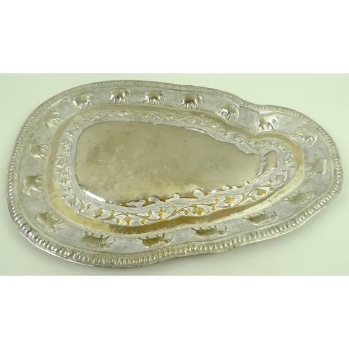 744 - An unmarked Ceylon silver metal tray, in the shape of Sri Lanka, impressed to the border with sevent... 