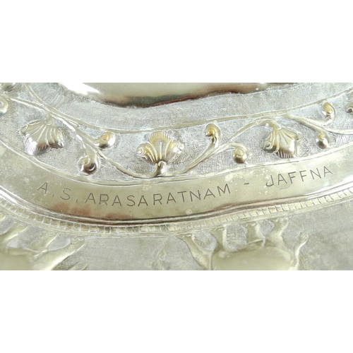 744 - An unmarked Ceylon silver metal tray, in the shape of Sri Lanka, impressed to the border with sevent... 