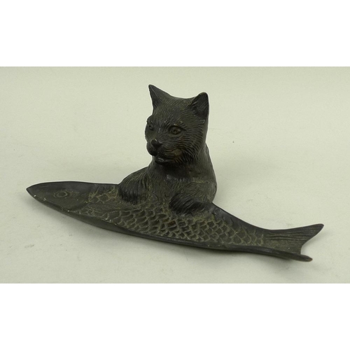 755 - A hollow cast patinated bronze desk tidy or tray, modelled as the upper half of a cat with paws rest... 