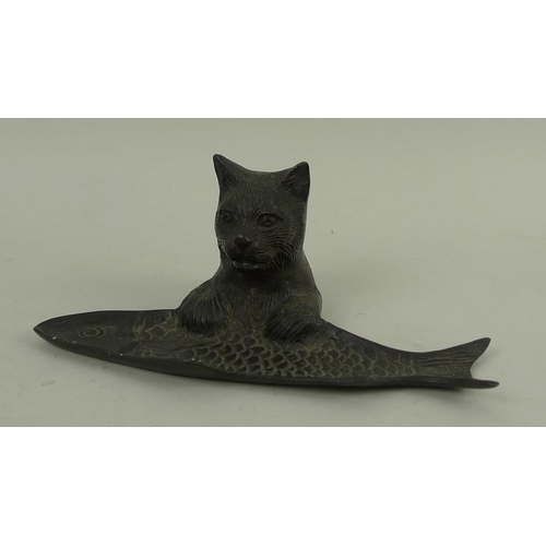 755 - A hollow cast patinated bronze desk tidy or tray, modelled as the upper half of a cat with paws rest... 