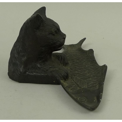 755 - A hollow cast patinated bronze desk tidy or tray, modelled as the upper half of a cat with paws rest... 